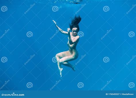 Slim Naked Woman Posing Underwater In Transparent Blue Ocean Nude