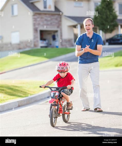 Caucasian Father Teaching Son To Ride Bicycle Stock Photo Alamy