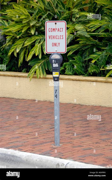 Compact car only parking sign and meter Stock Photo - Alamy