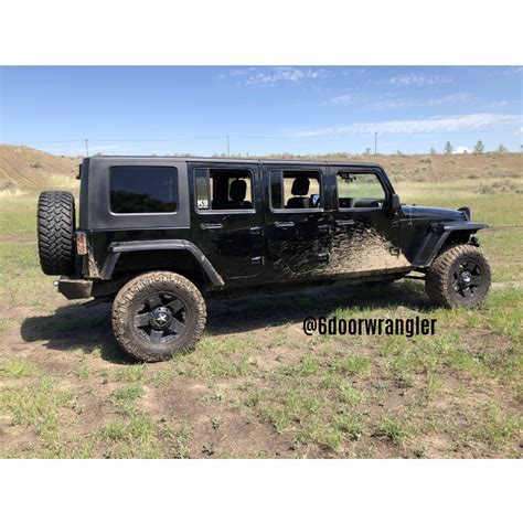 A Black Jeep Is Parked In The Middle Of A Field With No One Around It