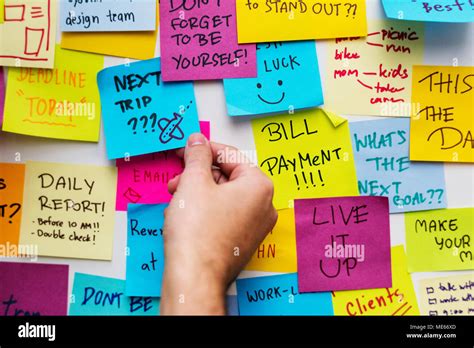 Sticky notes on an office wall Stock Photo - Alamy