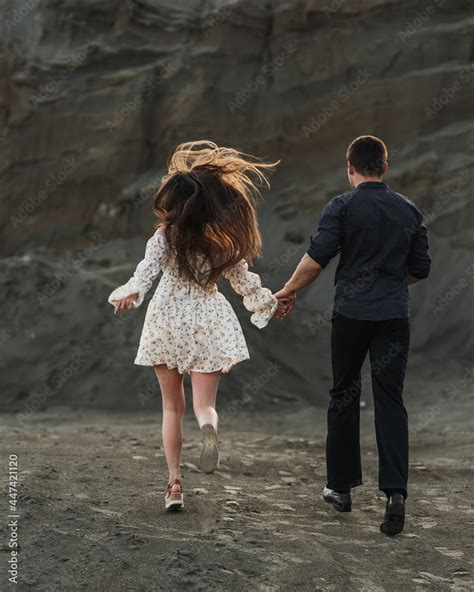 Couple Holding Hands Running