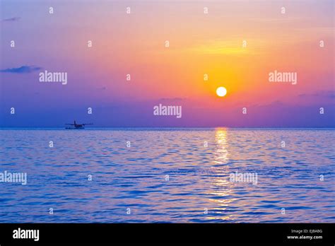 Seaplane at sunset - Maldives Stock Photo - Alamy