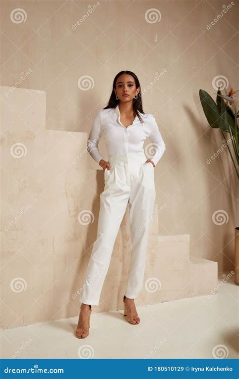 Beautiful Brunette Woman Tanned Skin Face Cosmetic Makeup Wear White Suit Pants For Date Walk