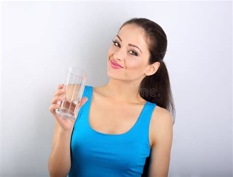 Young Beautiful Woman Drinking Fresh Pure Water From Glass On Bl Stock