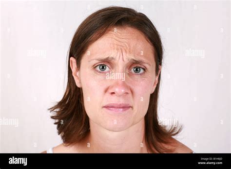 Young Brunette Woman Head Shot Closeup With Slightly Worried Anxious