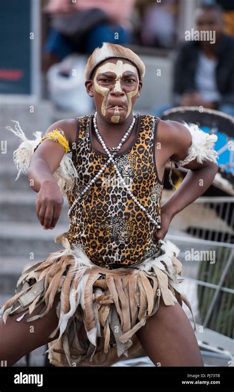 Man In Tribal African Clothes Entertaining Tourists On The Streets Of