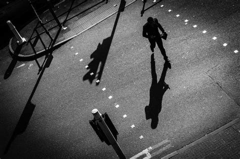 Premium Photo High Angle View Of Silhouette Man Walking On Road