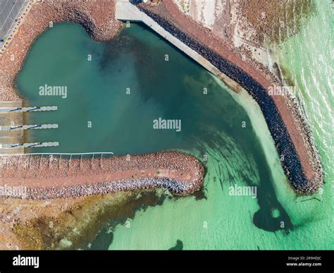 Aerial view of a coastal boat ramp surrounded by rocky breakwaters at Port Hughes on the Yorke ...