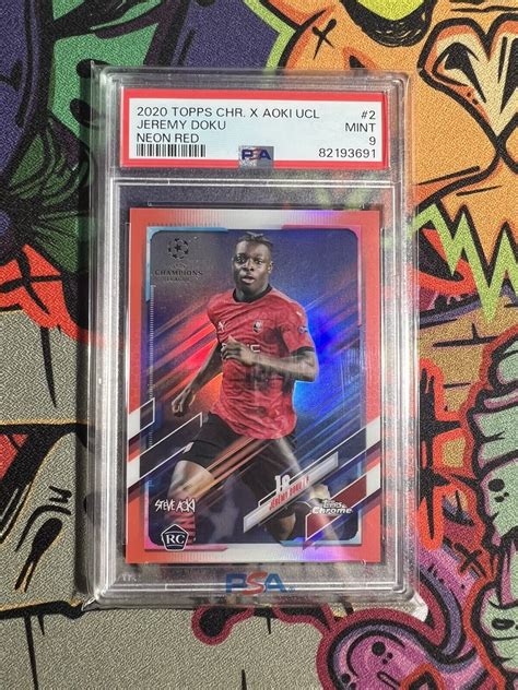 2020 21 Topps Chrome Steve Aoki UEFA Jeremy Doku Neon Red RC 5 PSA 9