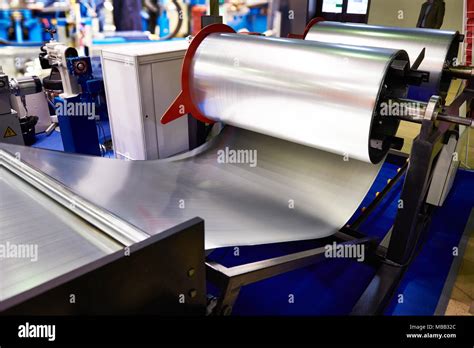 Rolls Of Sheet Metal On Industrial Equipment At Manufacture Stock Photo