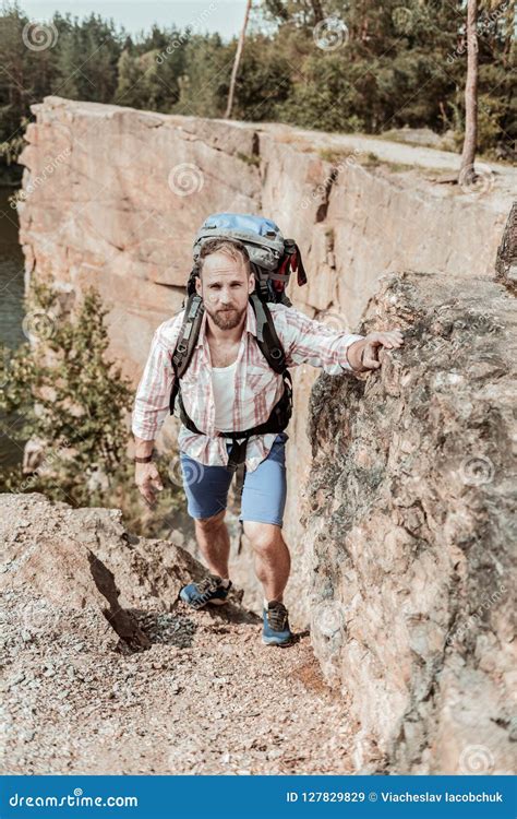 Hiker Wearing Shorts And Squared Shirt Hiking In The Mountains With