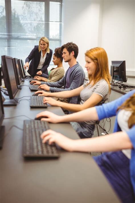 Premium Photo Computer Teacher Helping A Pretty Student In Her Class