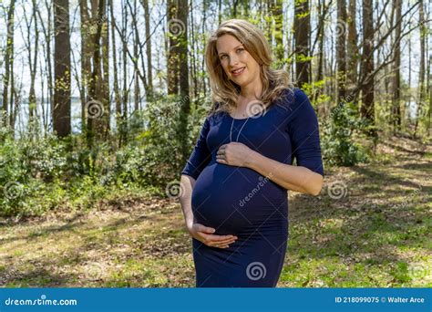 A Gorgeous Glowing Pregnant Woman Poses In An Outdoor Environment Stock Image Image Of