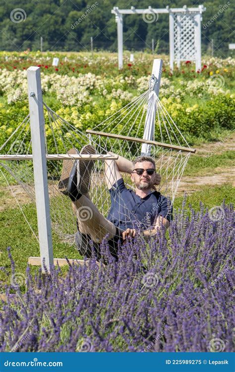 An Adult Male Years Old Lies With His Eyes Closed In A Hammock In