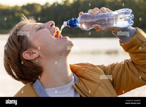 Refreshment By The Lake Quenching Thirst In Nature Stock Photo Alamy