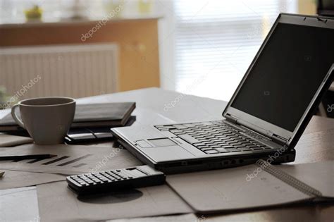 Workplace With Open Laptop With Black Screen And Business Documents