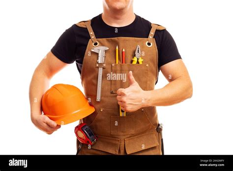 Contractor Worker Or Carpenter In Apron With Tools And Helmet Holding