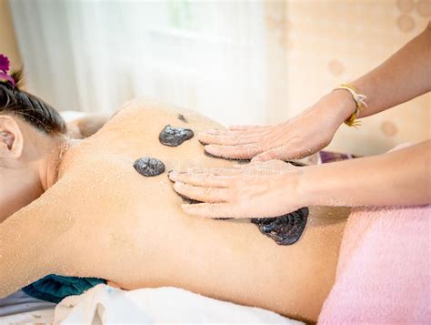 Naked Woman Is Getting Skin Scrub On Her Back In Spa Treatment Stock