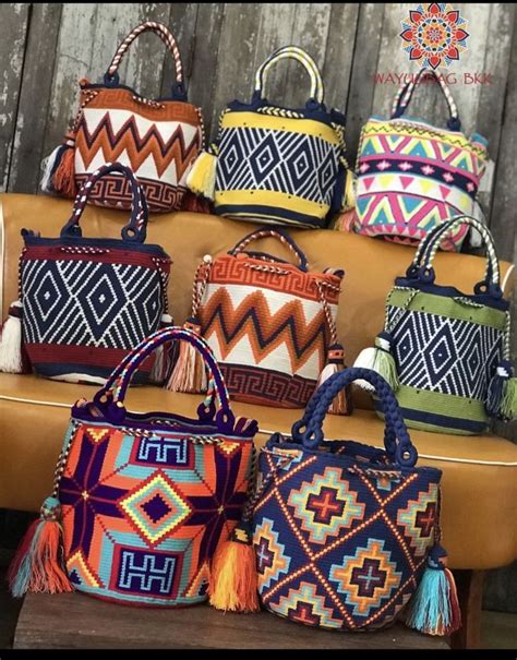 Several Colorful Bags Are On Display In Front Of A Wooden Wall With