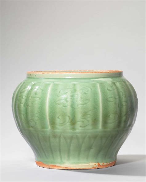 A Rare Longquan Celadon Carved And Moulded Sea Creatures Jar Yuan