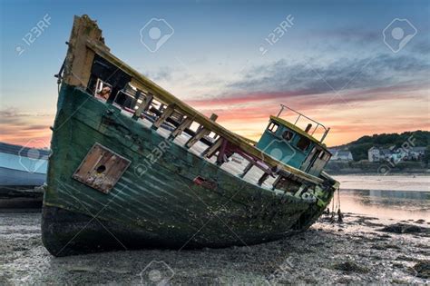 An Old Wrecked Wooden Boat On The Shore Stock Photo, Picture And ...