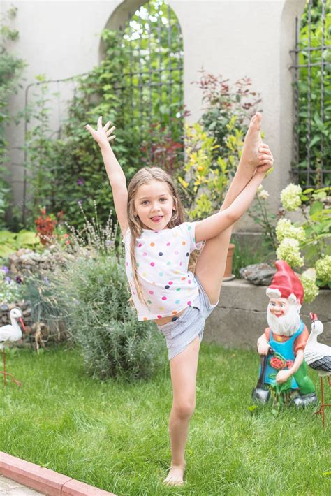 Free Photo Girl Stretching Her Leg Standing In Garden