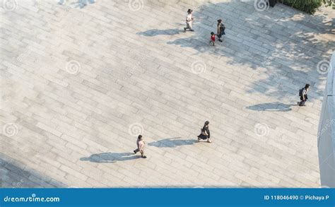 Crowd Of People Walk On Open Space Concrete Pavement From Top Vi