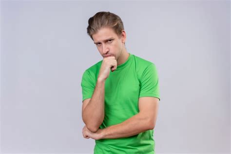 Free Photo Young Handsome Man Wearing Green T Shirt With Pensive