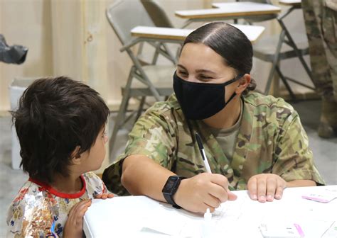 Guard Members Assist Us Afghan Civilians As Part Of Operation Allies