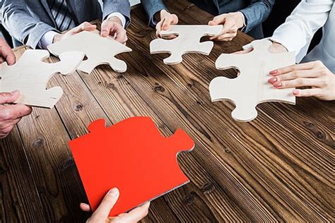 Group Of Business People Assembling Jigsaw Puzzle Women Games Team