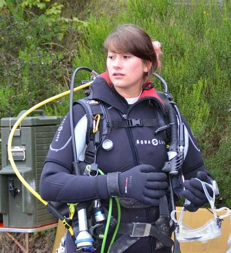 A Woman In Scuba Gear Is Standing Outside