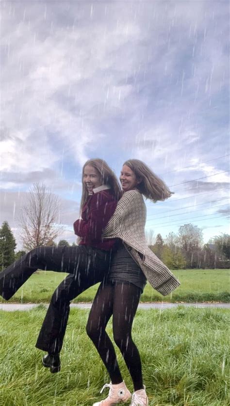 Two Girls Twirling Around In Each Others Arms In The Rain The Girls