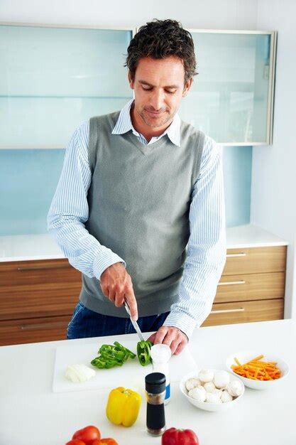 Premium Photo Handsome Mature Man Cooking In Kitchen Portrait Of A Handsome Mature Man Cooking
