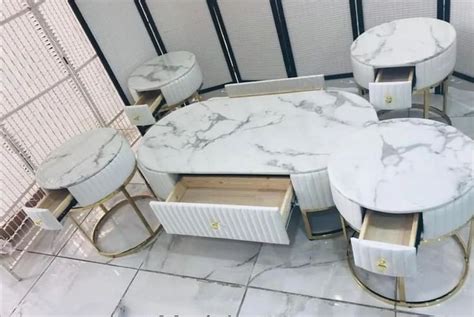 Marble Tables And Chairs Are Arranged In A Room