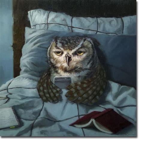 An Owl Sitting On Top Of A Bed Holding A Cell Phone