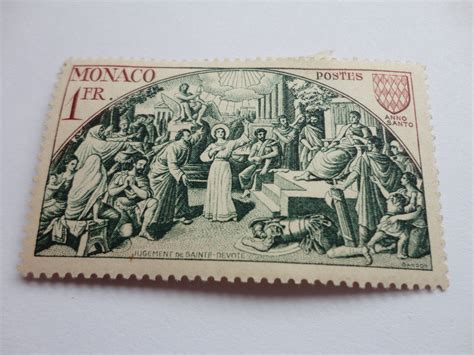 A Stamp With An Image Of Jesus And Other People In The Background On A