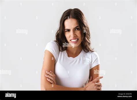 Brunette Caucasian Angry Girl Grimacing While Posing With Arms Crossed