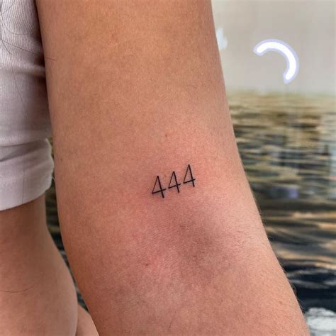 A Woman S Arm With The Number Four In Black Ink On Her Left Side