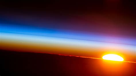 "An orbital sunrise is pictured from the International Space Station as ...