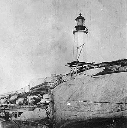 Landing with derrick, lighthouse in background (1907)