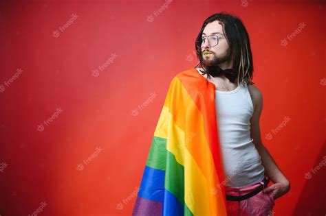 Premium Photo Handsome Young Man With Pride Movement Lgbt Rainbow Flag On Shoulder Against