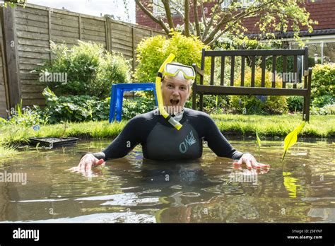 Mature Woman Having Fun Wearing Wetsuit Goggles Snorkel In Small Garden Pond Moving Pond