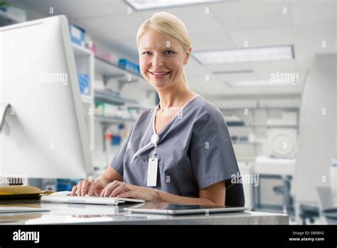 Caucasian Nurse Working At Computer In Hospital Stock Photo Alamy