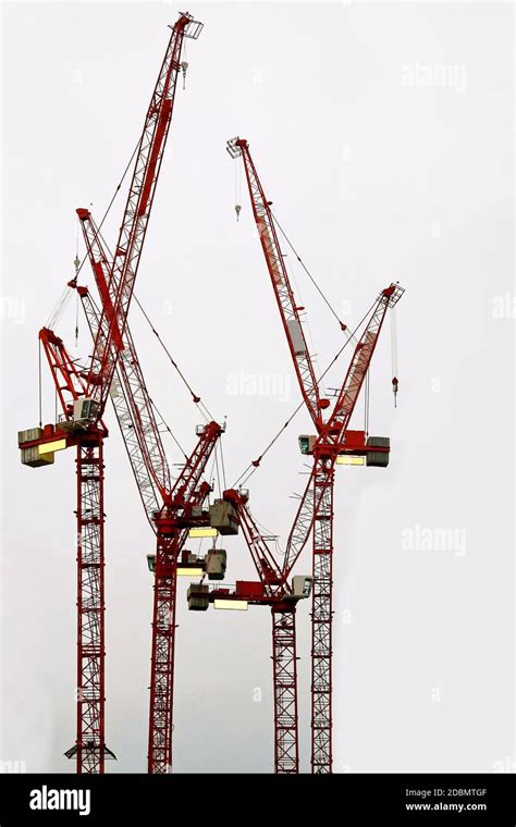 Four Red Construction Cranes With Long Booms Stock Photo Alamy