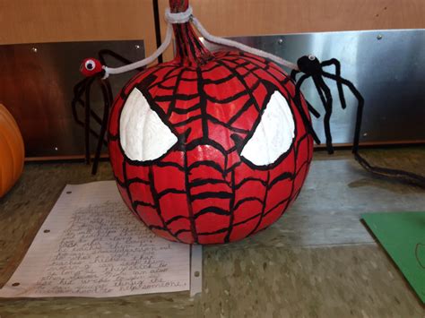 A Pumpkin Decorated To Look Like A Spider Man