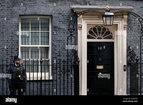 A Police Officer Stands Outside The Door Of Downing Street In London