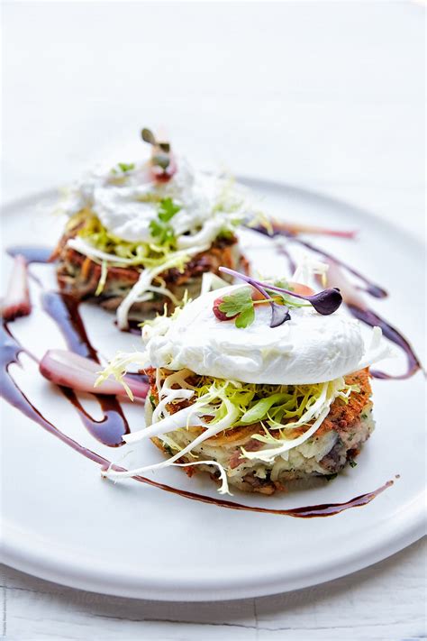 "Crispy Duck Confit Hash Frisee Salad With Poached Egg" by Stocksy Contributor "Trinette Reed ...