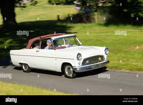 Panning Shot Of Classic White Mk 2 Ford Consul Convertible Driving