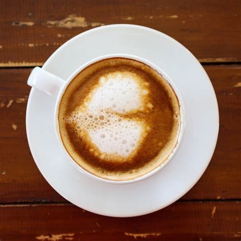 Premium Photo | Coffee cup on a wooden table